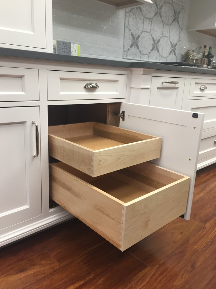 Kitchen - transitional kitchen idea in Boston with shaker cabinets, an island and white cabinets