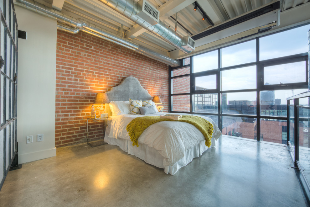 Inspiration for a large industrial master bedroom in Toronto with white walls, concrete floors, no fireplace and grey floor.