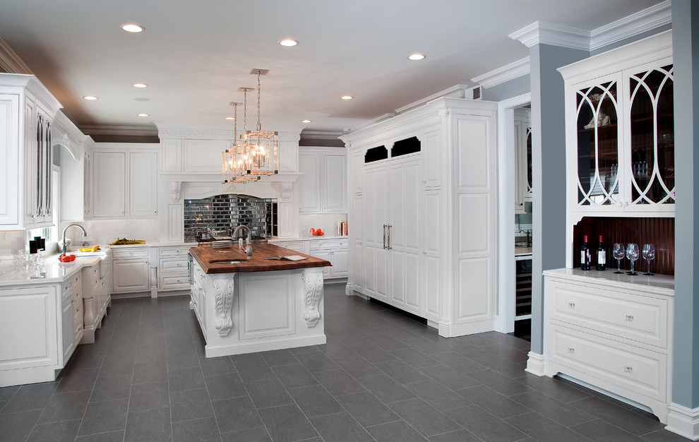 Design ideas for a large traditional u-shaped eat-in kitchen in New York with a farmhouse sink, beaded inset cabinets, white cabinets, marble benchtops, white splashback, stone tile splashback, panelled appliances, porcelain floors and with island.