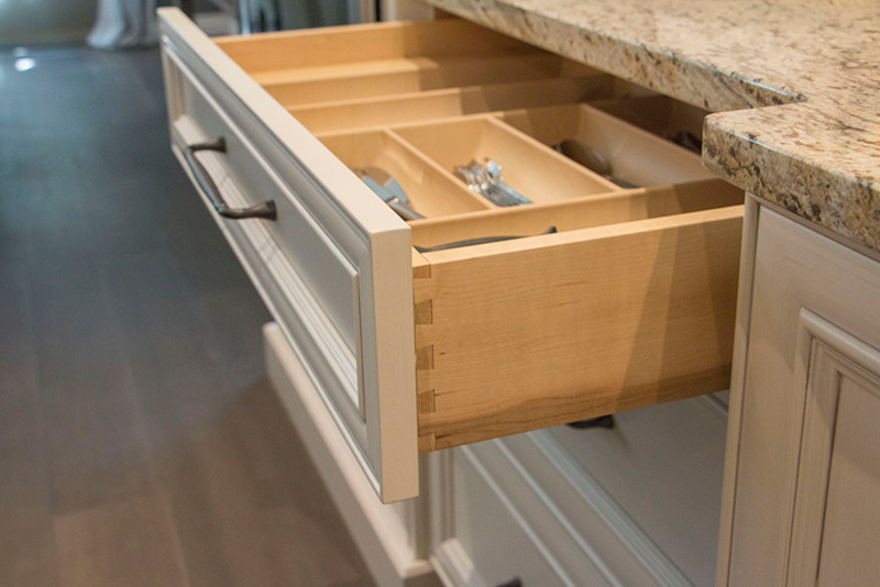 Inspiration for a large transitional l-shaped home design remodel with a double-bowl sink, shaker cabinets, white cabinets, beige backsplash, stainless steel appliances and an island