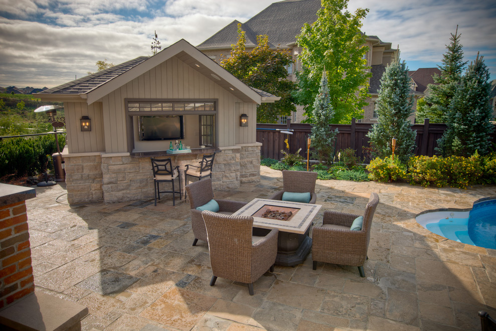 Design ideas for a large traditional backyard patio in Toronto with natural stone pavers and a gazebo/cabana.