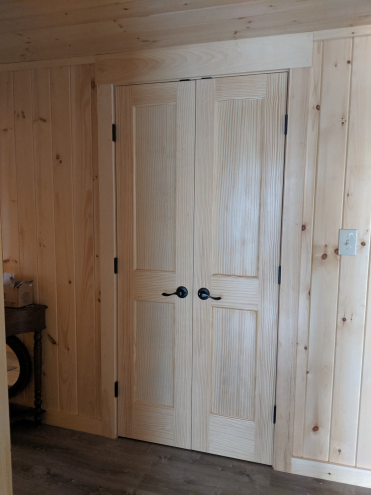 Design ideas for a small country galley laundry cupboard in Portland Maine with a stacked washer and dryer.