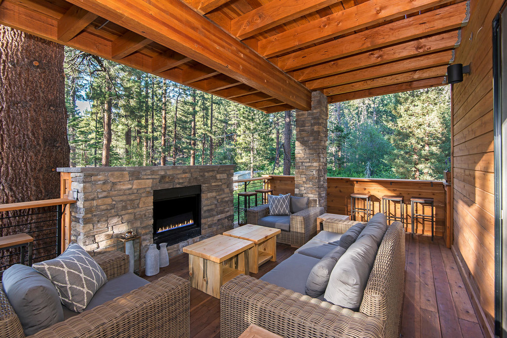 Photo of a country deck in Sacramento with a fire feature and a roof extension.