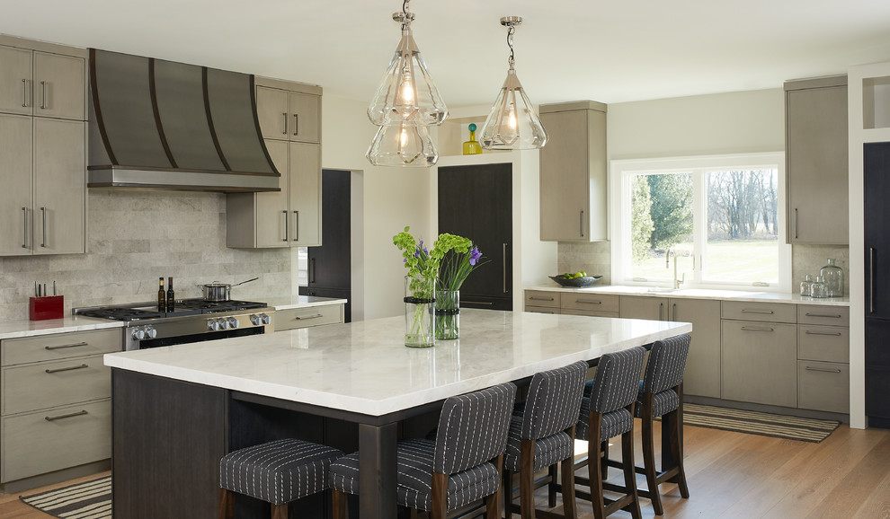 Large transitional l-shaped light wood floor and brown floor kitchen photo in Grand Rapids with an undermount sink, flat-panel cabinets, quartzite countertops, an island, gray cabinets, gray backsplash, stainless steel appliances, white countertops and stone tile backsplash