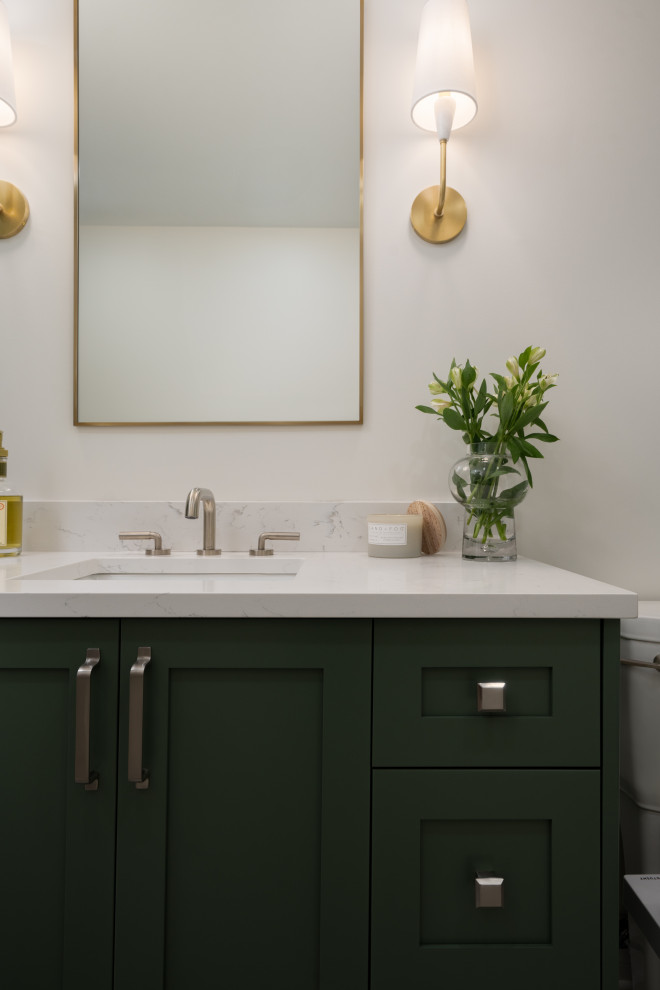 Photo of a small modern kids bathroom in Montreal with shaker cabinets, green cabinets, an alcove tub, an alcove shower, a one-piece toilet, white tile, ceramic tile, white walls, mosaic tile floors, an undermount sink, engineered quartz benchtops, beige floor, a sliding shower screen, white benchtops, a single vanity and a freestanding vanity.