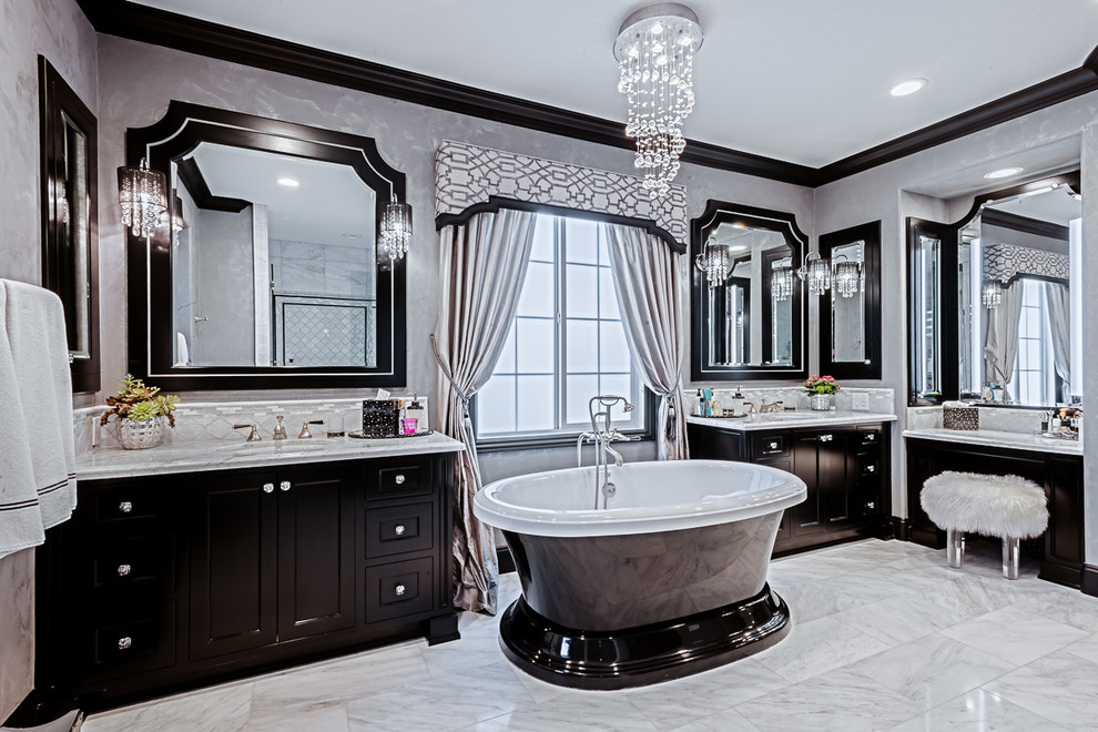 Large transitional master white tile and stone slab marble floor and white floor freestanding bathtub photo in Orange County with recessed-panel cabinets, black cabinets, marble countertops, a two-piece toilet, gray walls, an undermount sink and a hinged shower door