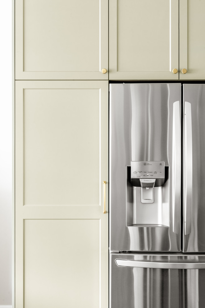 Kitchen - small transitional brown floor kitchen idea with shaker cabinets, green cabinets, white backsplash, stainless steel appliances, an island and white countertops