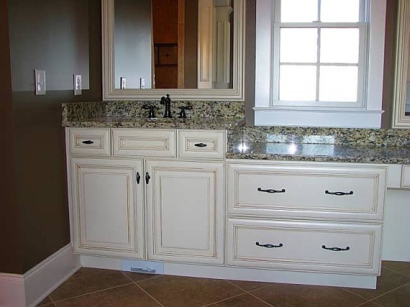 Inspiration for a ceramic tile bathroom remodel with an undermount sink, recessed-panel cabinets, white cabinets, granite countertops and brown walls
