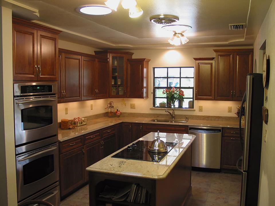 Enclosed kitchen - mid-sized transitional u-shaped ceramic tile and beige floor enclosed kitchen idea in Orlando with a double-bowl sink, raised-panel cabinets, medium tone wood cabinets, granite countertops, stone slab backsplash, stainless steel appliances and an island