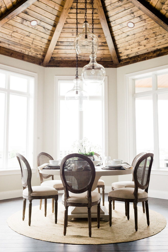 Beach style dining room in Other with beige walls and dark hardwood floors.