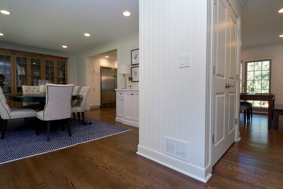 Inspiration for a mid-sized transitional dark wood floor, brown floor and wall paneling enclosed dining room remodel in Chicago with white walls and no fireplace