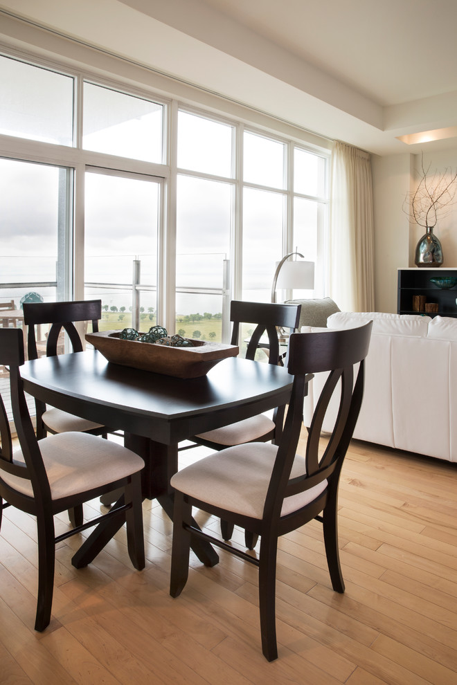 Inspiration for a large transitional light wood floor great room remodel in Milwaukee with white walls and no fireplace