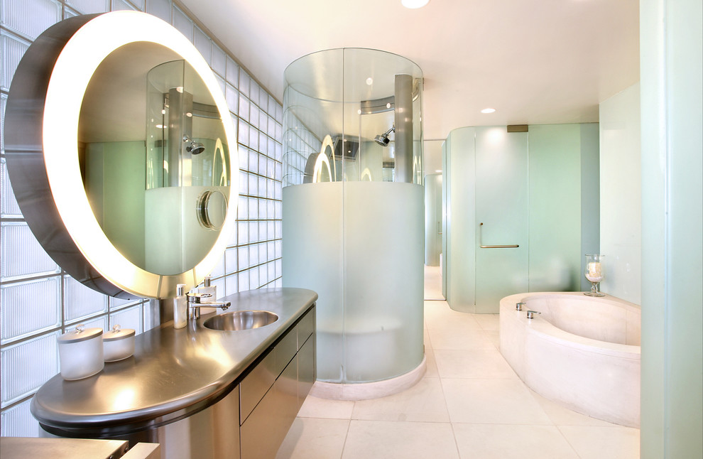 Inspiration for a large modern master bathroom in Orange County with a drop-in sink, flat-panel cabinets, stainless steel benchtops, a corner tub, a corner shower, a one-piece toilet, white tile, ceramic tile and ceramic floors.