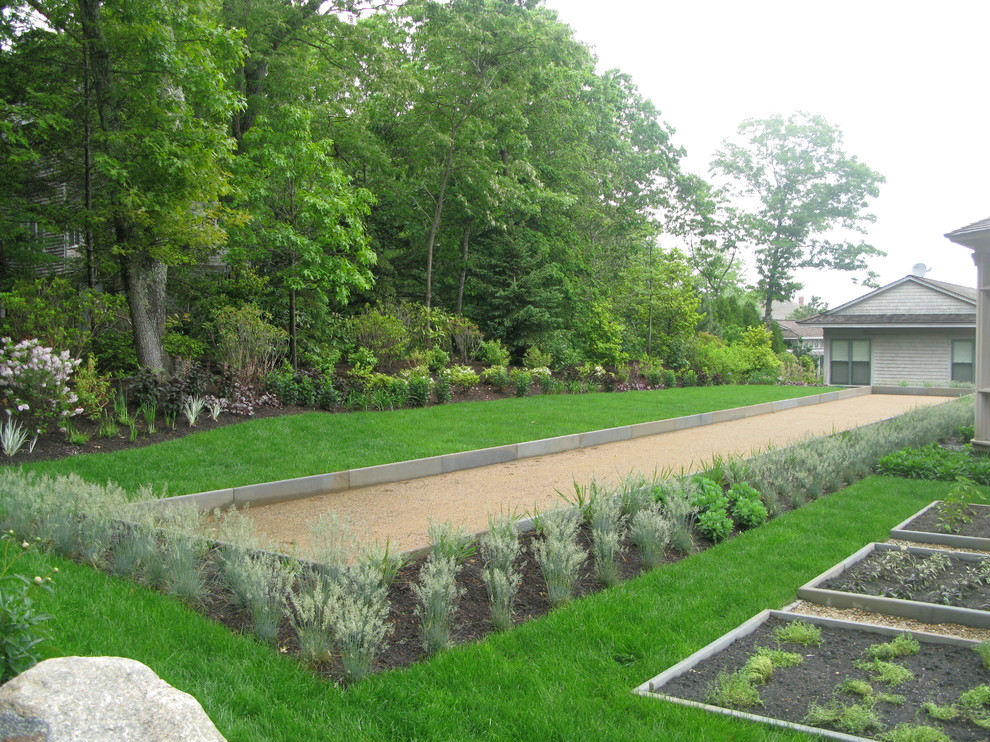 Inspiration for a large beach style backyard full sun formal garden in Boston with a container garden and gravel.