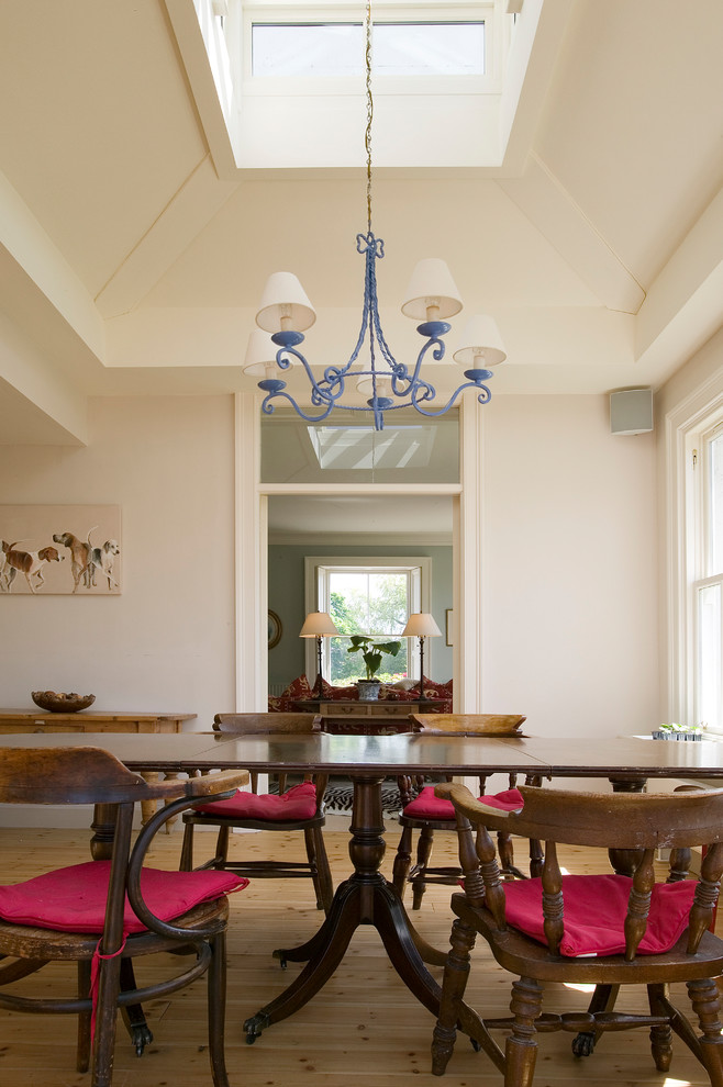 Inspiration for a large traditional separate dining room in Other with white walls and light hardwood floors.