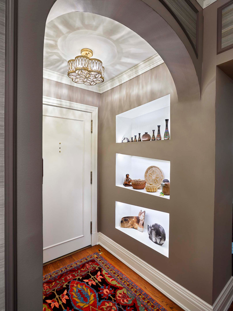 Example of a small transitional medium tone wood floor and brown floor front door design with gray walls and a white front door