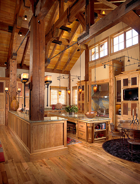 Inspiration for a large rustic light wood floor open concept kitchen remodel with glass-front cabinets, light wood cabinets, granite countertops, paneled appliances and an island