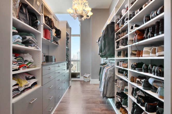 Inspiration for a large contemporary gender-neutral walk-in wardrobe in Austin with porcelain floors, brown floor and grey cabinets.