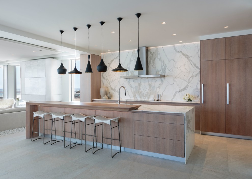 Design ideas for a large contemporary galley eat-in kitchen in Los Angeles with flat-panel cabinets, with island, medium wood cabinets, white splashback, stone slab splashback, panelled appliances, grey floor and white benchtop.