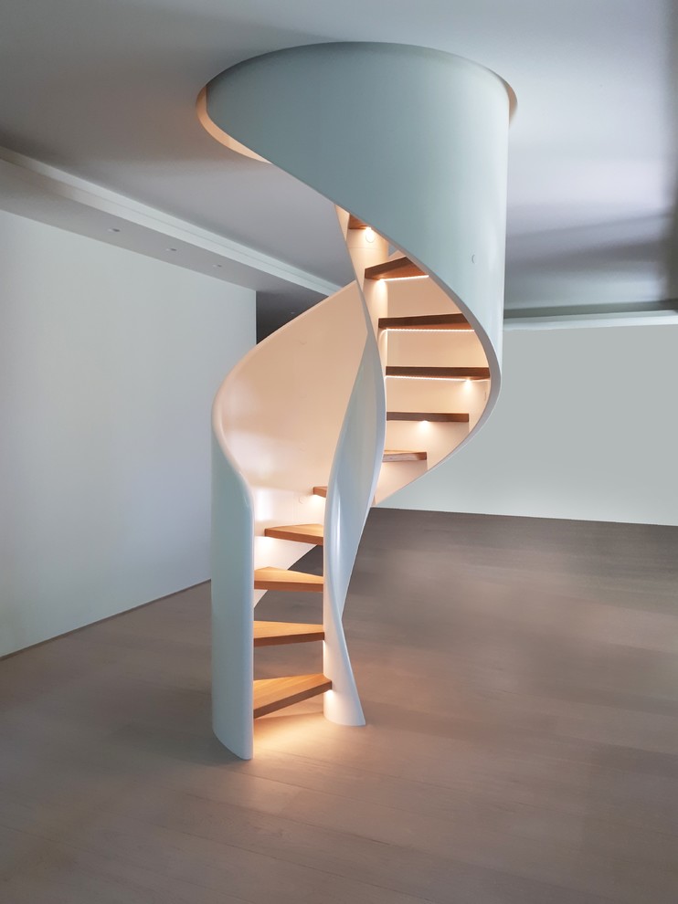 This is an example of a contemporary wood spiral staircase in Other with open risers.