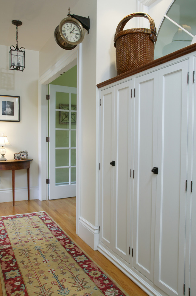 Inspiration for a traditional hallway in Boston with beige walls and medium hardwood floors.