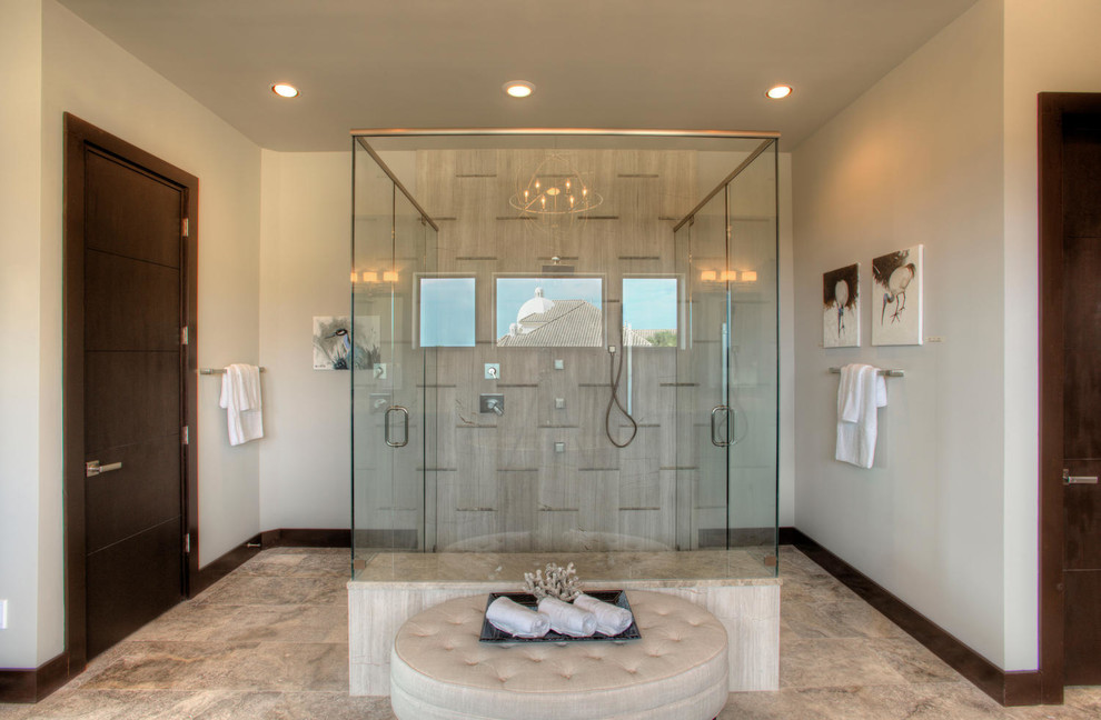 Inspiration for a large contemporary master bathroom in Austin with flat-panel cabinets, dark wood cabinets, a freestanding tub, beige tile, beige walls, a vessel sink, granite benchtops, beige floor, a hinged shower door and a curbless shower.
