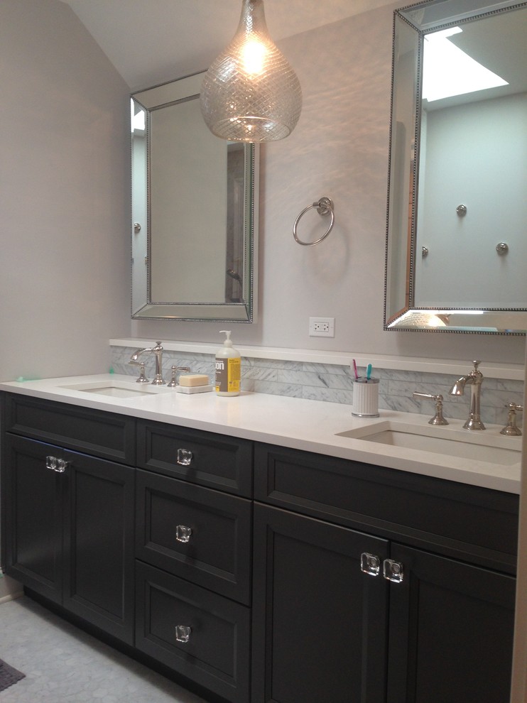 This is an example of a mid-sized contemporary master bathroom in Chicago with recessed-panel cabinets, black cabinets, subway tile, white walls, linoleum floors, an undermount sink, marble benchtops and an alcove shower.