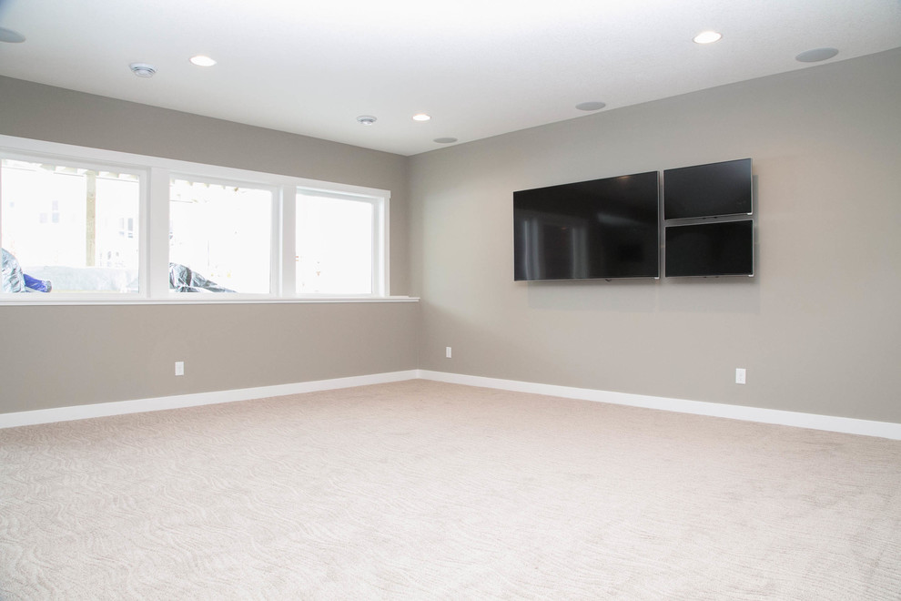 Example of a transitional look-out carpeted basement design in Minneapolis with gray walls and no fireplace