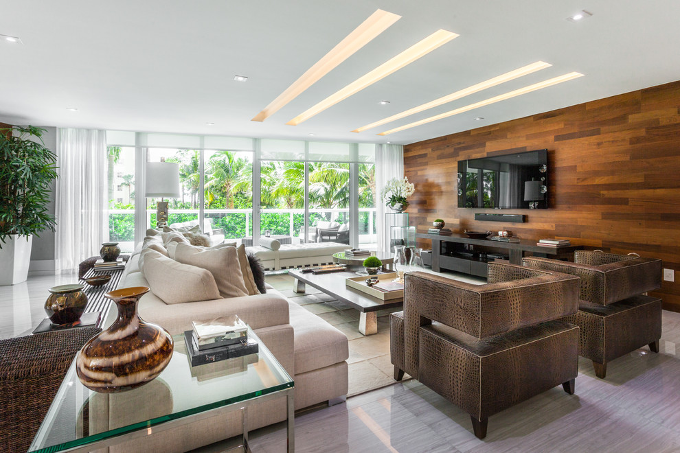 Photo of a large contemporary open concept living room in Miami with white walls, linoleum floors, no fireplace and a wall-mounted tv.