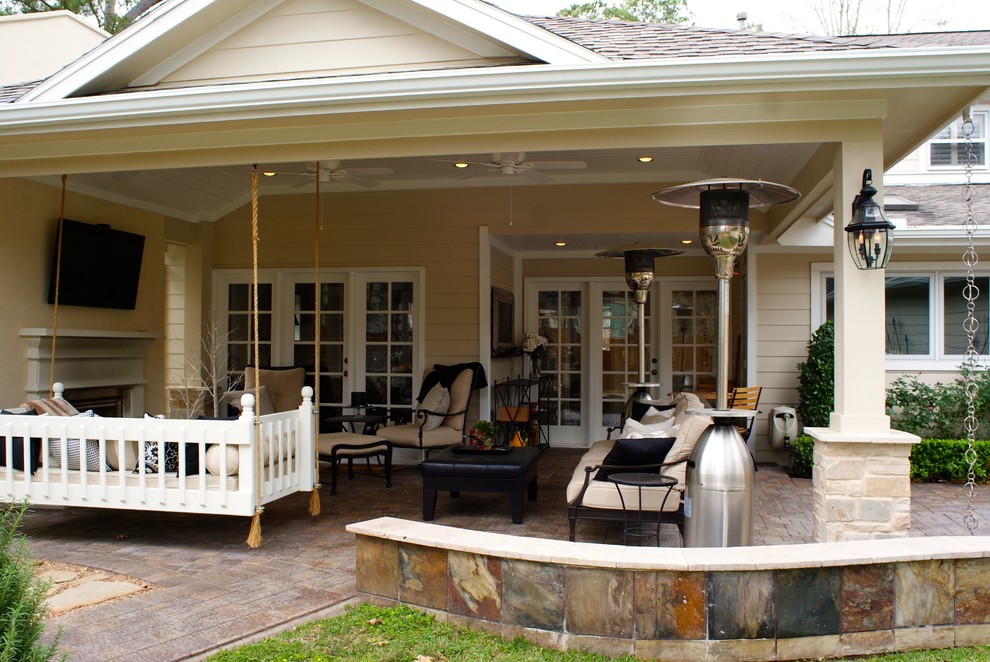 Inspiration for a mid-sized country backyard patio in Houston with a fire feature, brick pavers and a roof extension.