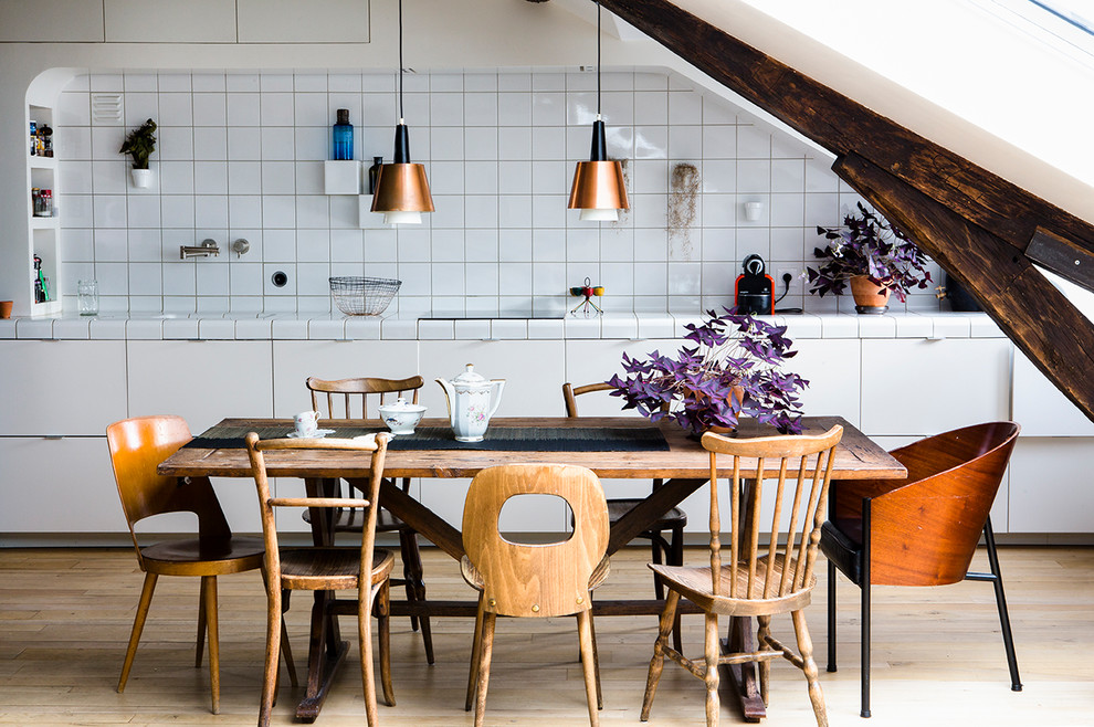 Inspiration for a mid-sized contemporary open plan dining in Paris with light hardwood floors and beige floor.