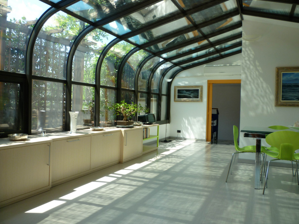 Inspiration for a large contemporary sunroom in Milan with light hardwood floors, a glass ceiling and white floor.