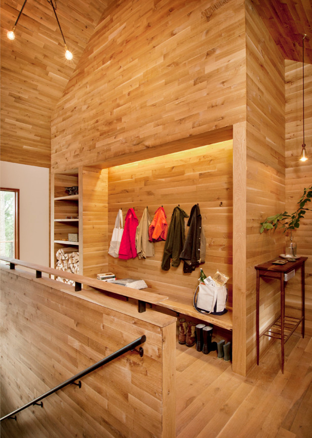 Contemporary mudroom in New York with light hardwood floors.