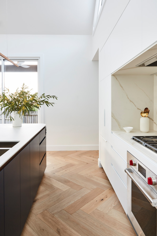 Design ideas for a scandinavian galley kitchen pantry in Sydney with a drop-in sink, white cabinets, quartz benchtops, beige splashback, marble splashback, with island, beige floor and white benchtop.