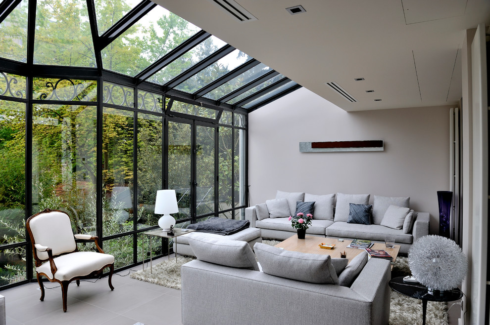 Mid-sized contemporary sunroom in Paris with a glass ceiling, ceramic floors, no fireplace and grey floor.