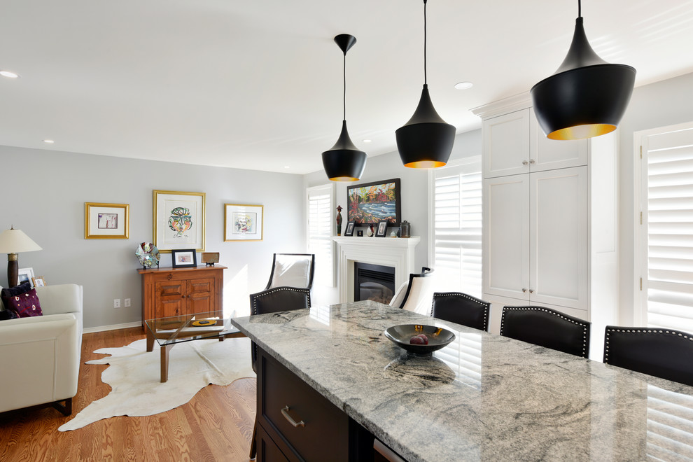 Example of a large transitional u-shaped light wood floor and beige floor open concept kitchen design in Ottawa with an undermount sink, shaker cabinets, white cabinets, granite countertops, white backsplash, subway tile backsplash, stainless steel appliances, an island and gray countertops