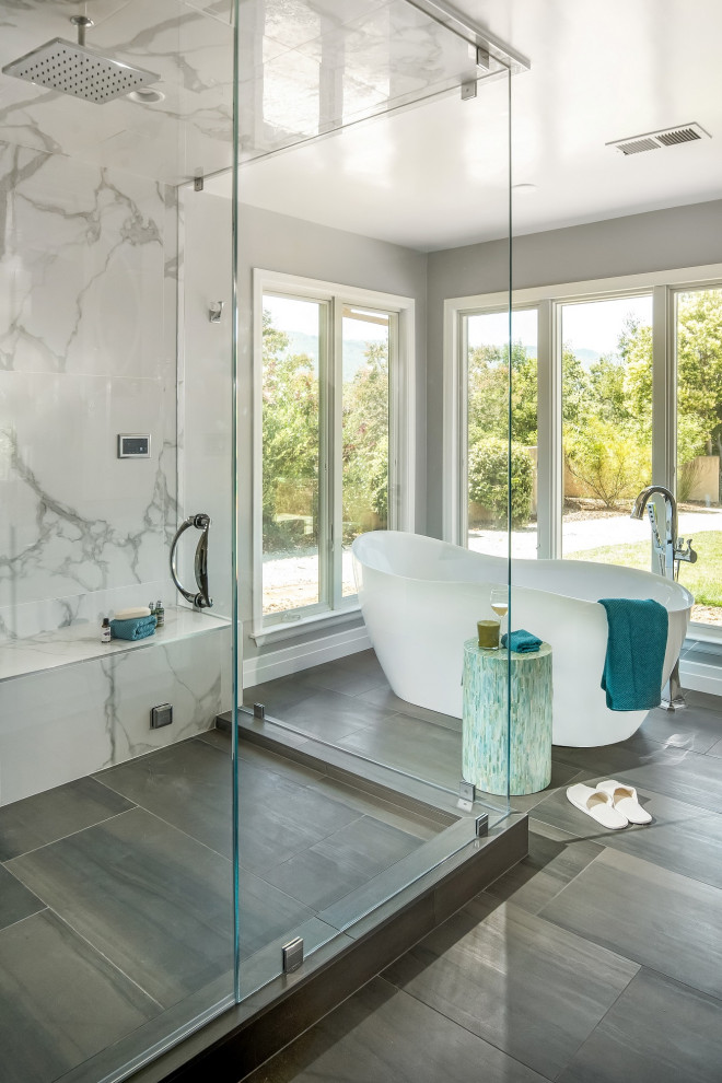 Photo of a large transitional master wet room bathroom in San Francisco with shaker cabinets, white cabinets, a freestanding tub, a one-piece toilet, multi-coloured tile, porcelain tile, grey walls, porcelain floors, an undermount sink, engineered quartz benchtops, multi-coloured floor, a hinged shower door, grey benchtops, a shower seat, a double vanity and a built-in vanity.