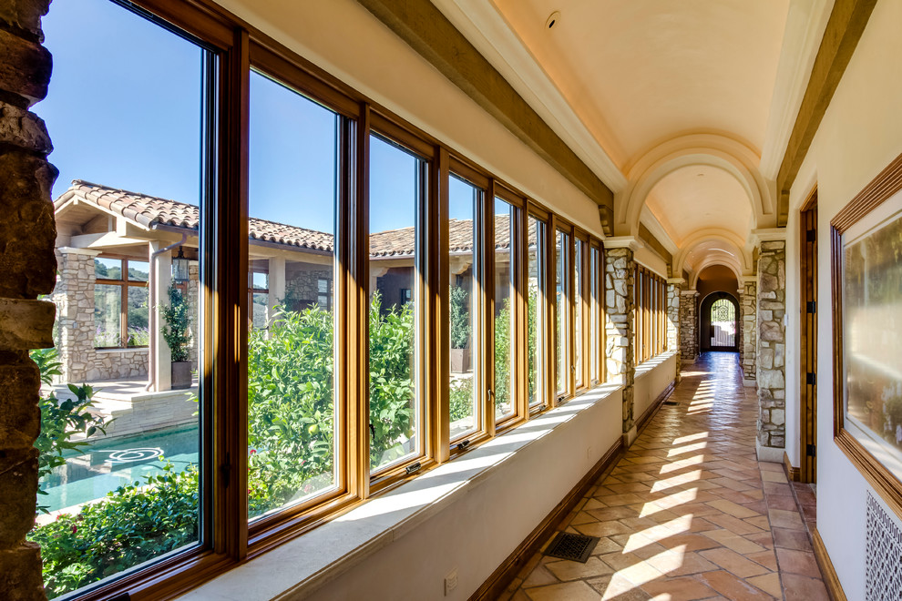 Photo of a mediterranean hallway in San Luis Obispo with beige walls and orange floor.