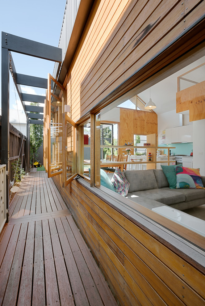 Photo of a mid-sized contemporary one-storey brown exterior in Melbourne with wood siding and a gable roof.