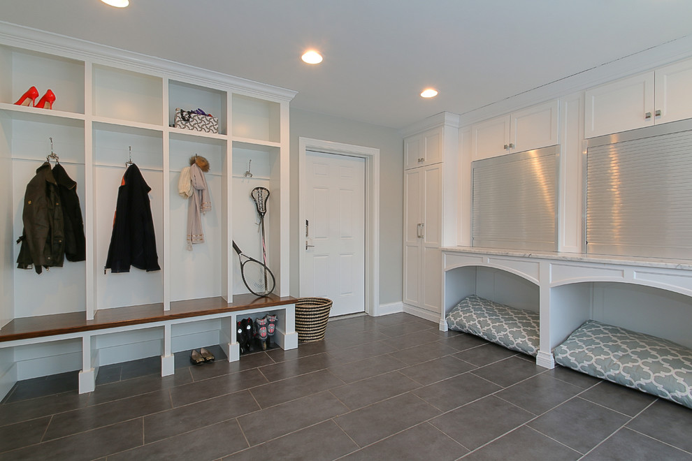 Inspiration for a mid-sized transitional laundry room in Chicago with shaker cabinets, white cabinets, marble benchtops, grey walls, ceramic floors and a side-by-side washer and dryer.