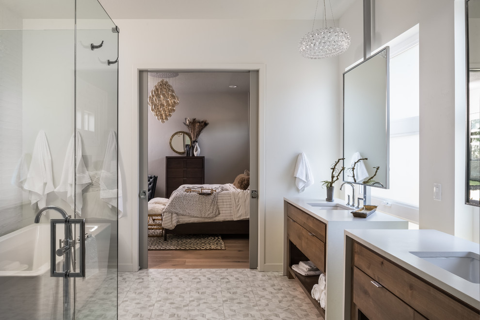 Large transitional master bathroom in Boise with a freestanding tub, flat-panel cabinets, dark wood cabinets, a corner shower, white walls, an undermount sink and a hinged shower door.