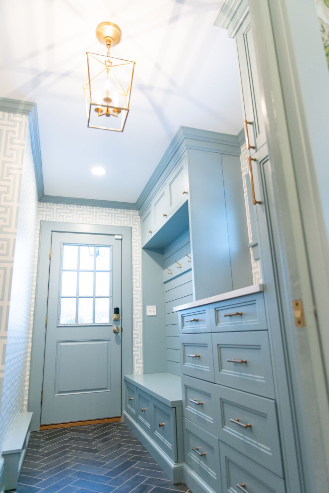 Photo of a mid-sized transitional mudroom in New York with blue walls, ceramic floors, a single front door, a blue front door, grey floor and wallpaper.