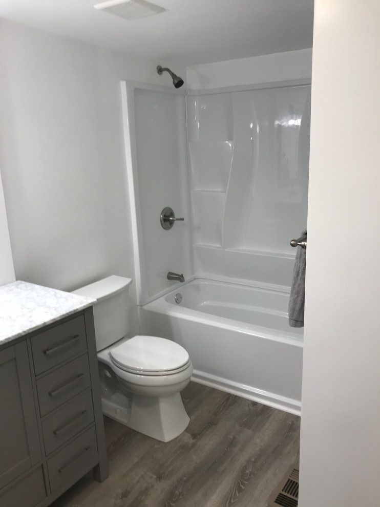 Mid-sized country kids bathroom in Portland Maine with shaker cabinets, grey cabinets, a two-piece toilet, multi-coloured tile, porcelain tile, white walls, vinyl floors, an undermount sink, quartzite benchtops, multi-coloured floor, an open shower and multi-coloured benchtops.