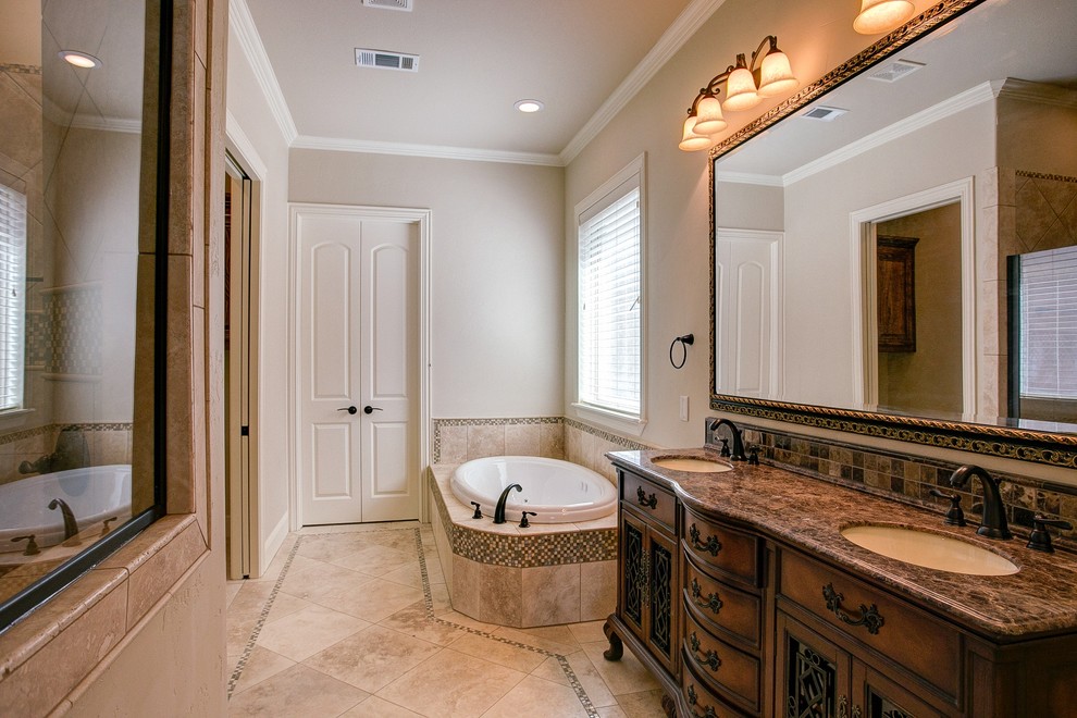 Mid-sized traditional master wet room bathroom in Dallas with furniture-like cabinets, dark wood cabinets, a drop-in tub, a two-piece toilet, beige tile, brown tile, multi-coloured tile, mosaic tile, beige walls, travertine floors, an undermount sink, granite benchtops and beige floor.