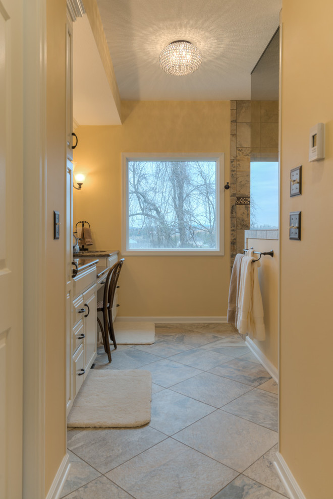 Example of a mid-sized transitional master multicolored tile ceramic tile doorless shower design with raised-panel cabinets, beige cabinets, a two-piece toilet, beige walls, an undermount sink and quartz countertops