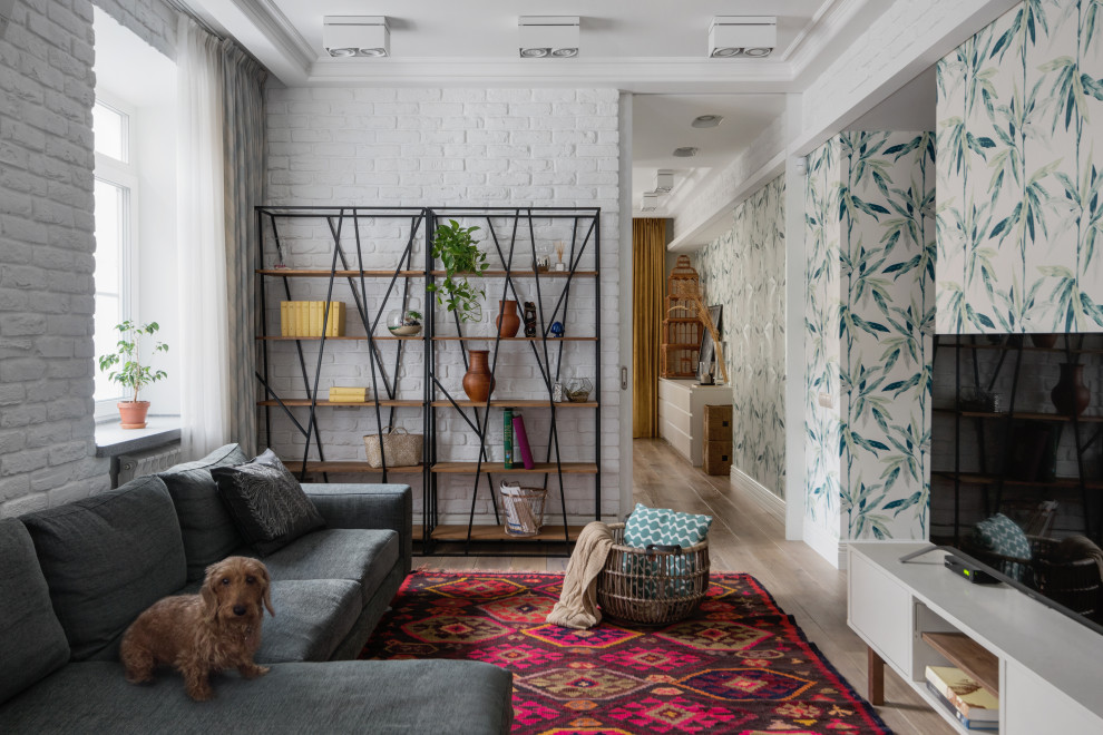 This is an example of a medium sized scandi grey and white open plan living room in Moscow with white walls, light hardwood flooring, a freestanding tv, beige floors, a drop ceiling and wallpapered walls.