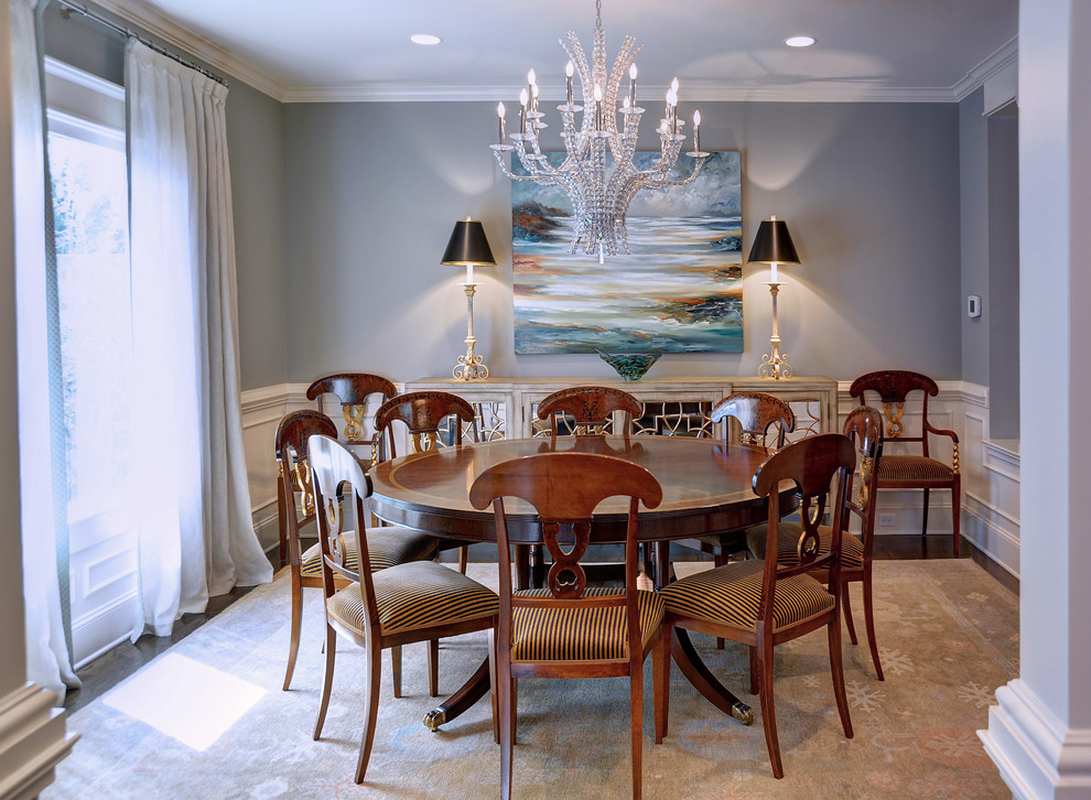 Example of a mid-sized transitional medium tone wood floor dining room design with gray walls and no fireplace