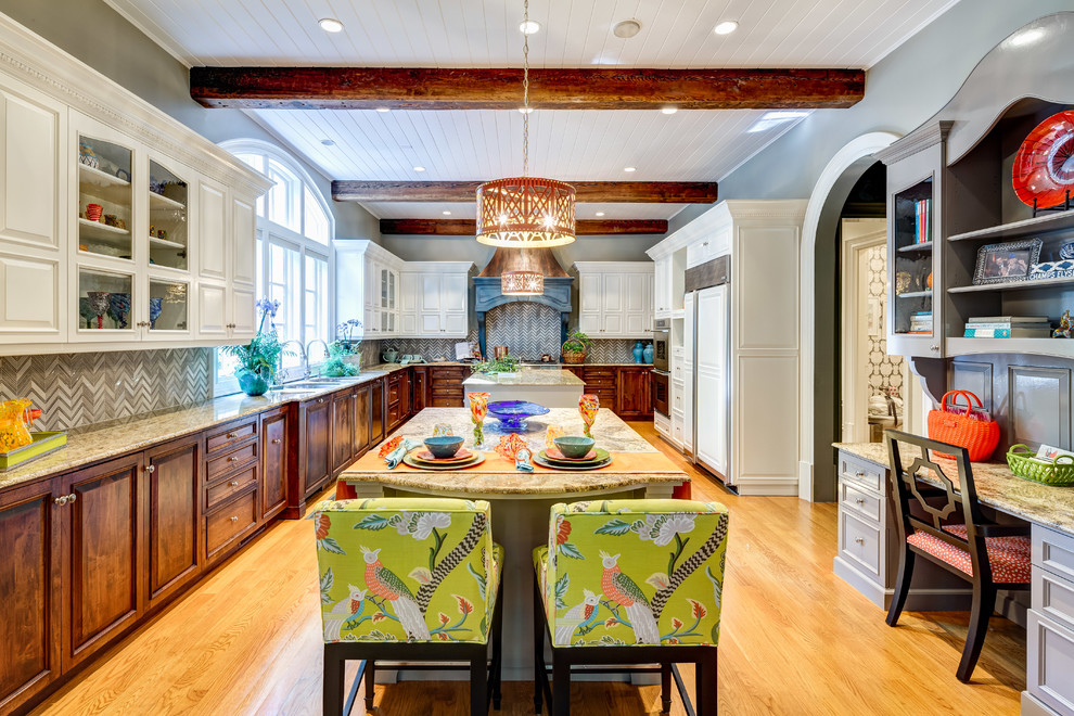 This is an example of a large traditional galley open plan kitchen in Atlanta with a double-bowl sink, raised-panel cabinets, white cabinets, granite benchtops, grey splashback, stone tile splashback, coloured appliances, light hardwood floors, multiple islands, beige floor and beige benchtop.