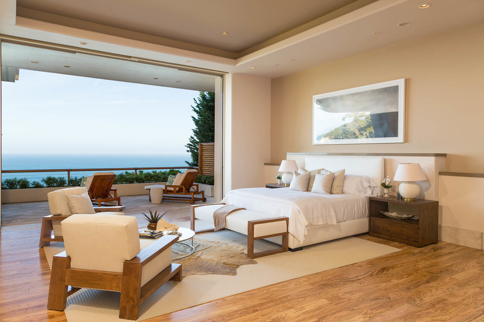 This is an example of a beach style bedroom in Los Angeles with beige walls and no fireplace.