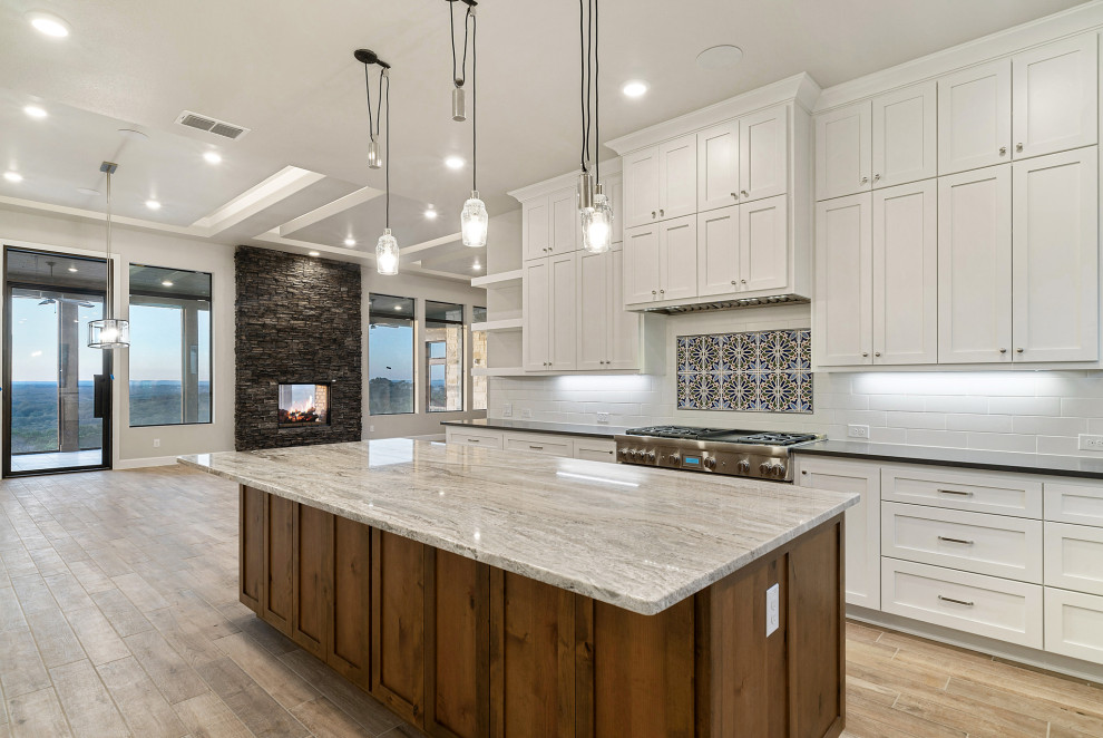 Design ideas for a mid-sized country kitchen in Austin with a double-bowl sink, granite benchtops, ceramic splashback, stainless steel appliances, ceramic floors, with island, brown floor and brown benchtop.